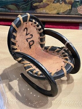 Handcrafted Iron Horseshoes & Natural Leather Accent Rocking Chair Decor.
